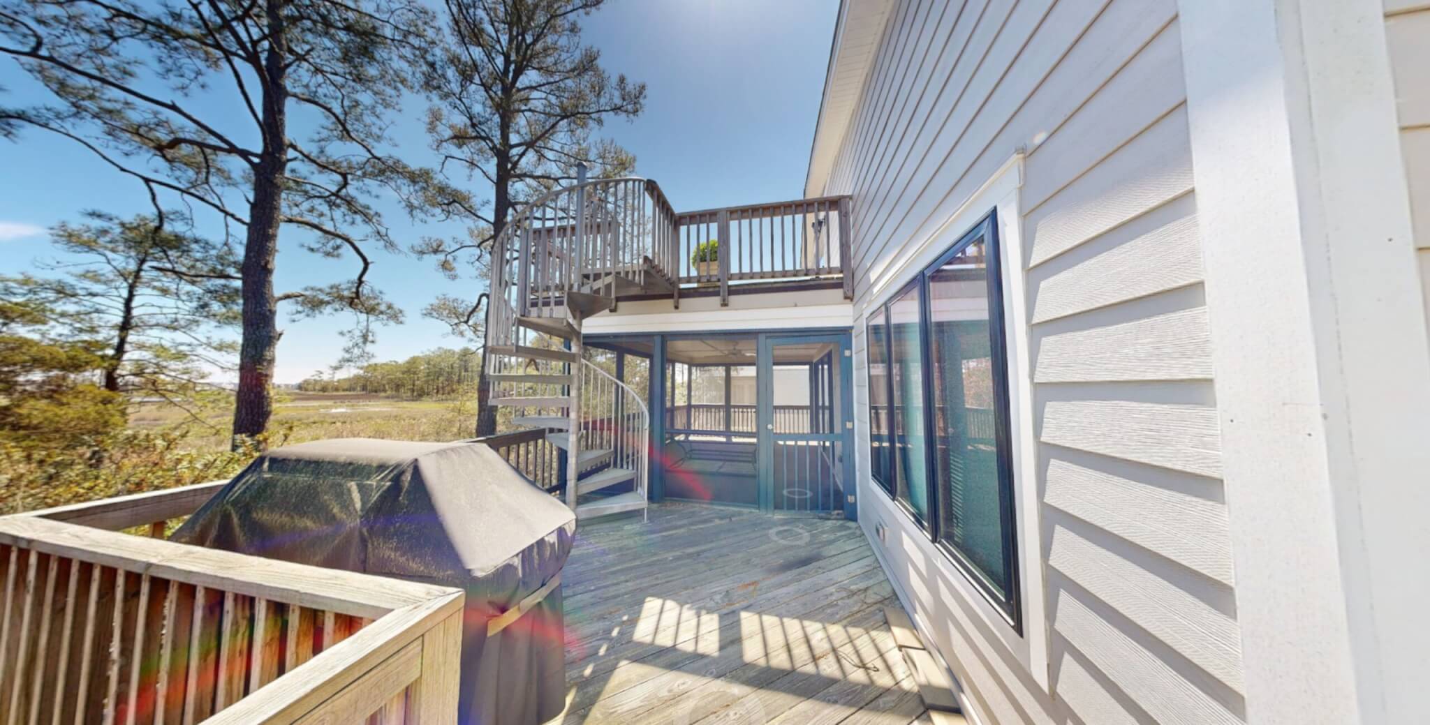 Kent Sunroom Renovation in Bethany Beach DE with Storm Door, Dark Floor Tiles, Wood Bench Seat and Light Sea Foam Wall Paint