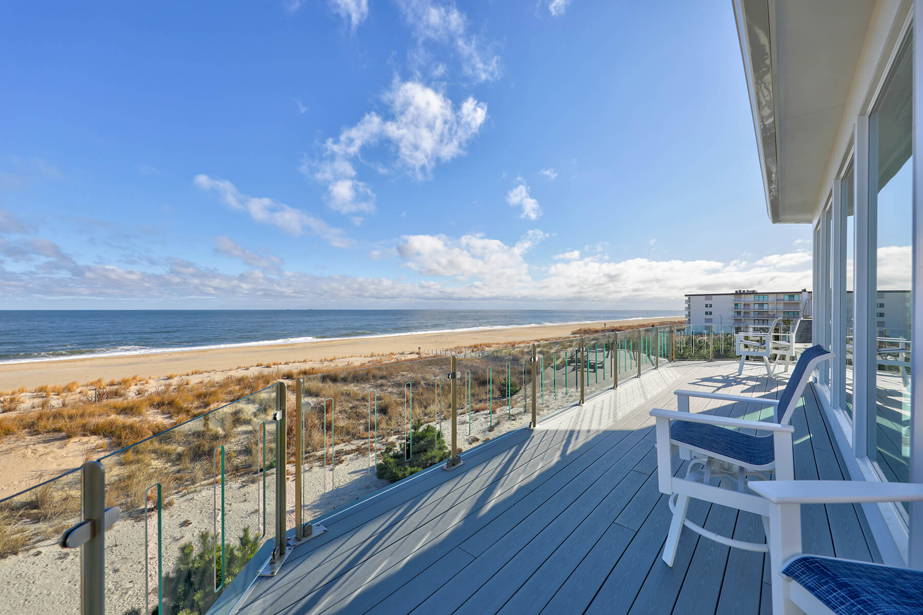 Deck Renovation in Campbell Place, Bethany Beach DE - Table with Six Wooden Chairs and Stainless Steel Grill