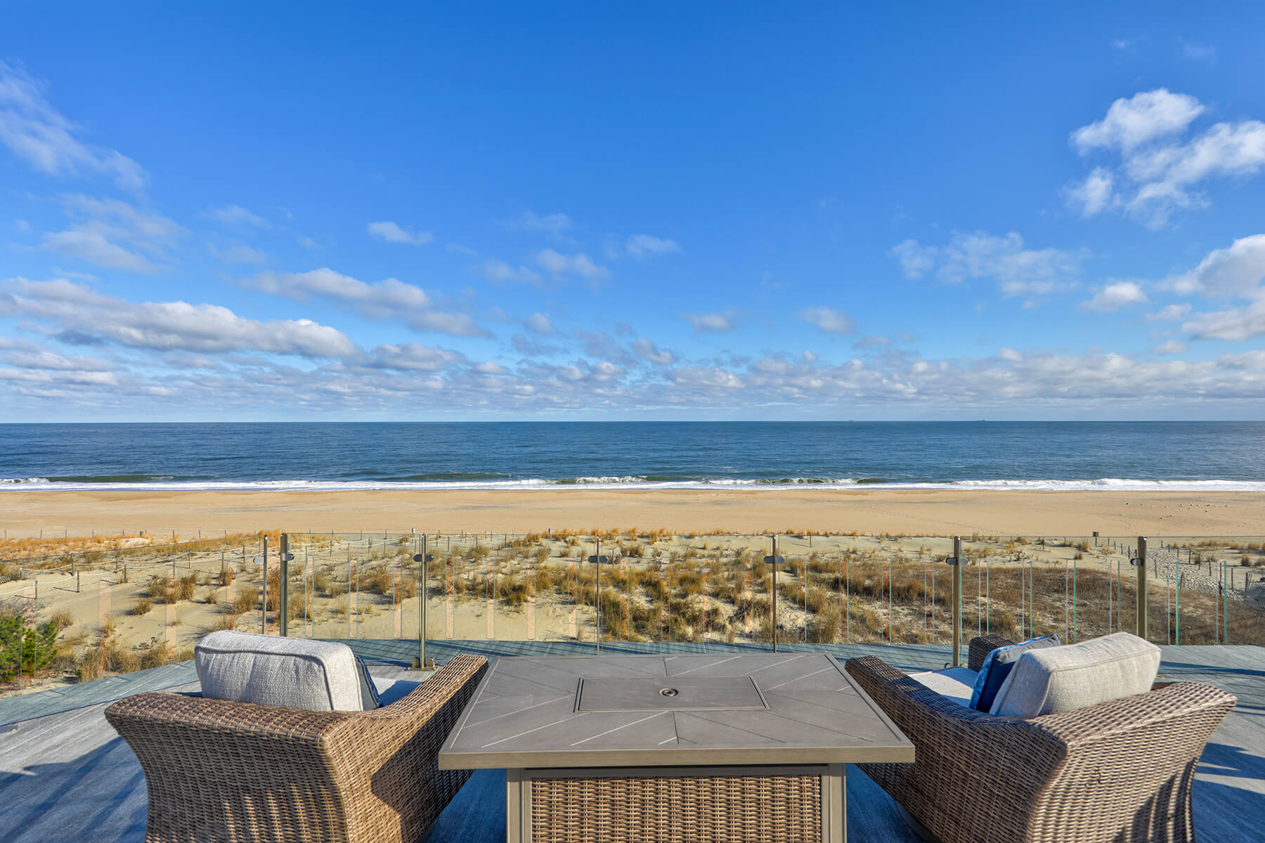 Deck Renovation in Campbell Place, Bethany Beach DE - Table with Six Wooden Chairs and Stainless Steel Grill