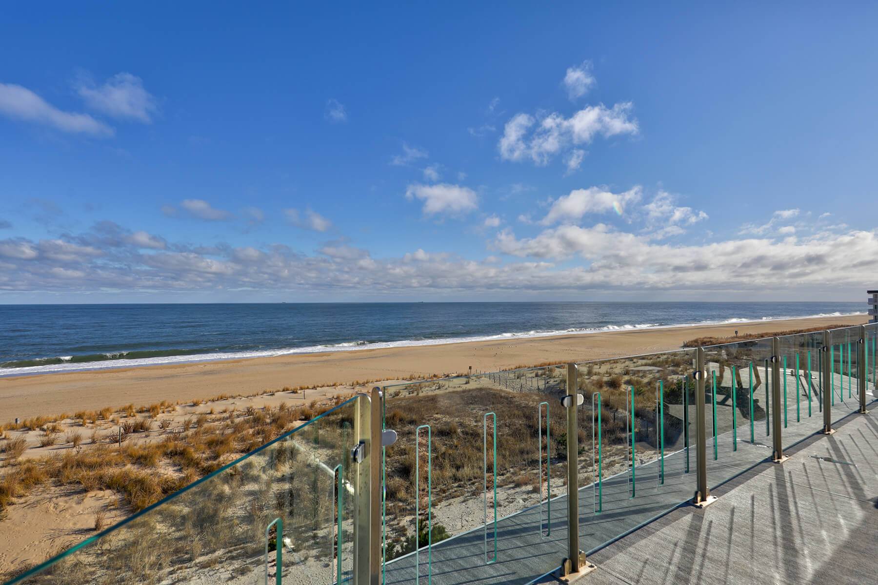 Deck Renovation in Campbell Place, Bethany Beach DE - Table with Six Wooden Chairs and Stainless Steel Grill