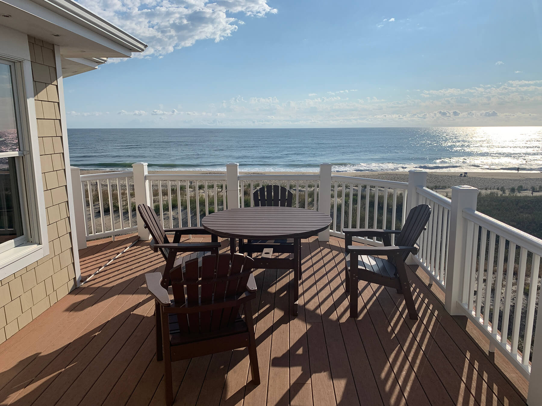 Deck Renovation in Campbell Place, Bethany Beach DE - Table with Six Wooden Chairs and Stainless Steel Grill