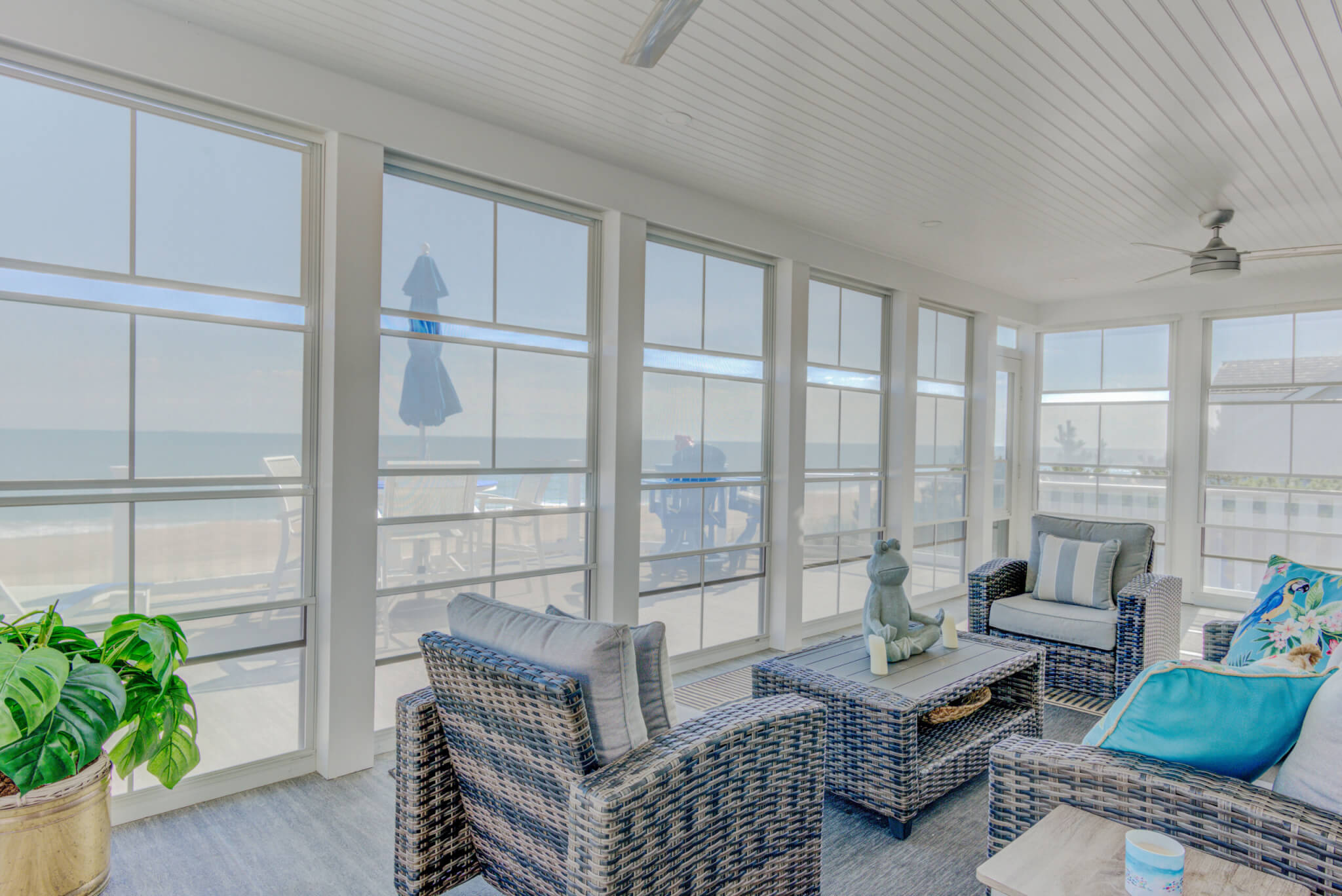 Sunroom with Teal Carpet and Rattan Furniture