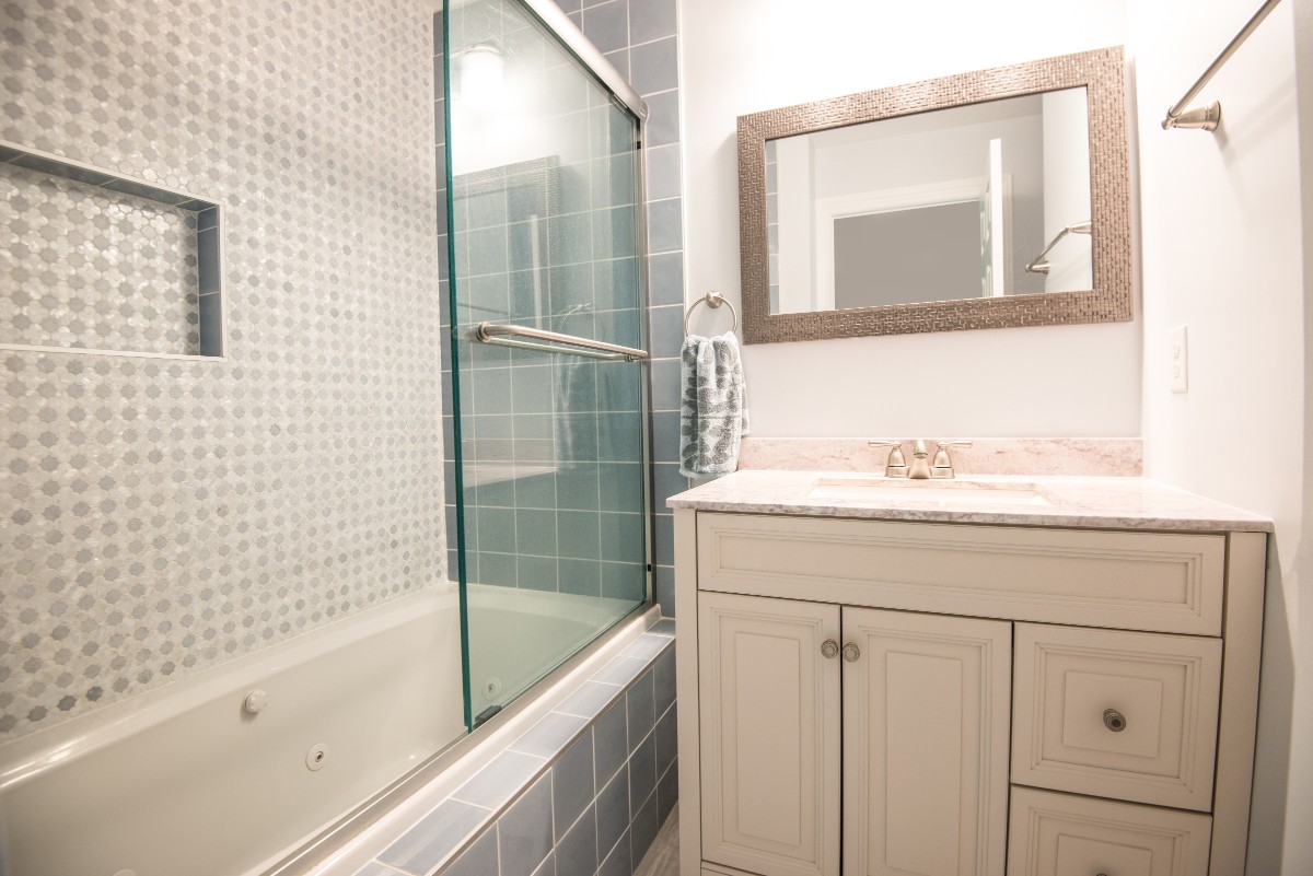 Bethany Lakes Renovation Bethany Beach, DE Bathroom with White Vanity, Tub, Arpell Azul Mosaic Wall Tiles and Snape Gloss Tiles