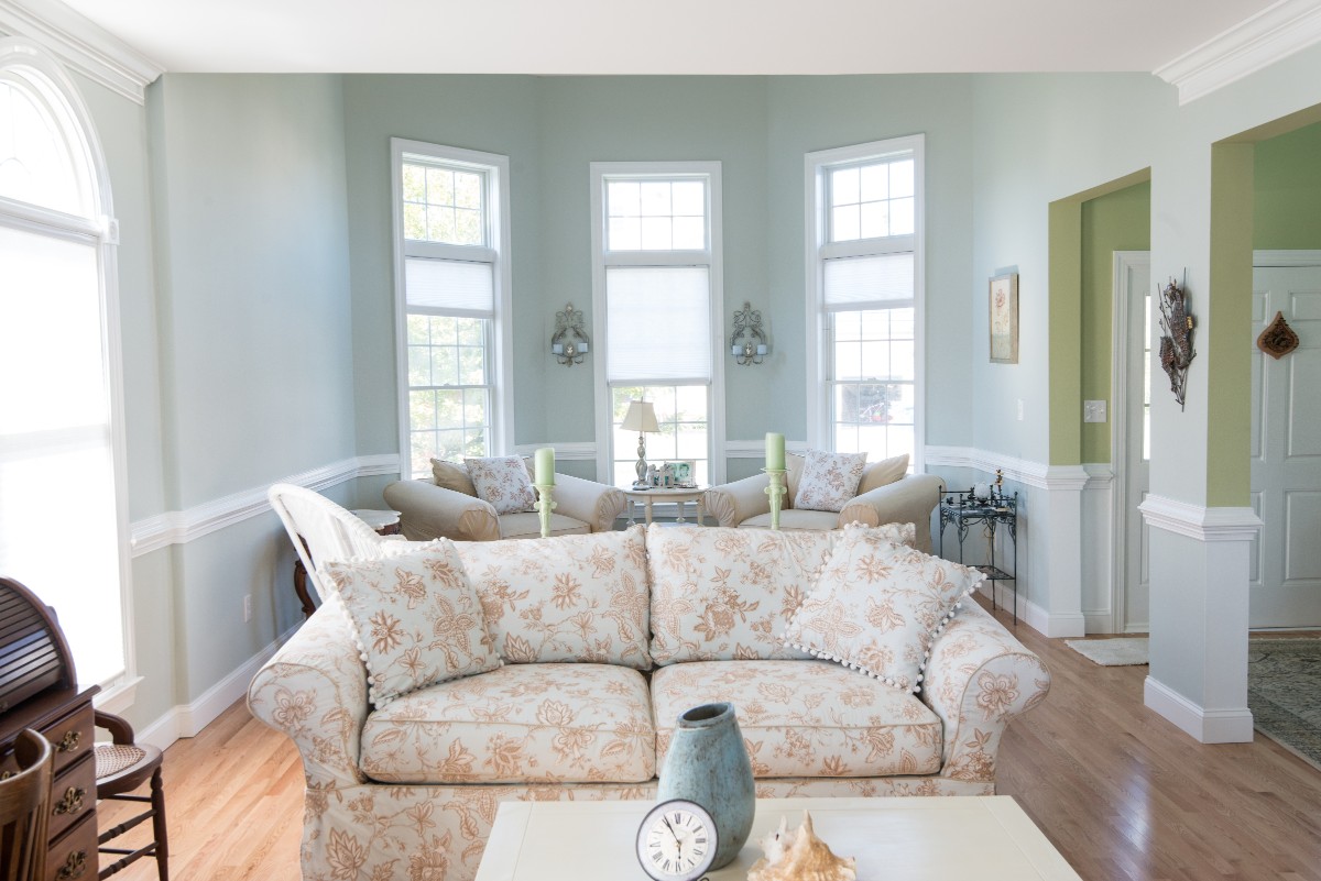 Bethany Lakes Renovation Bethany Beach, DE with Large Sofa, Vintage Furniture and Tall Windows