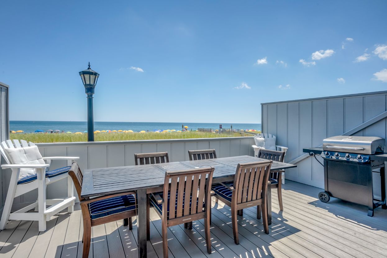 Deck Renovation in Campbell Place, Bethany Beach DE - Table with Six Wooden Chairs and Stainless Steel Grill
