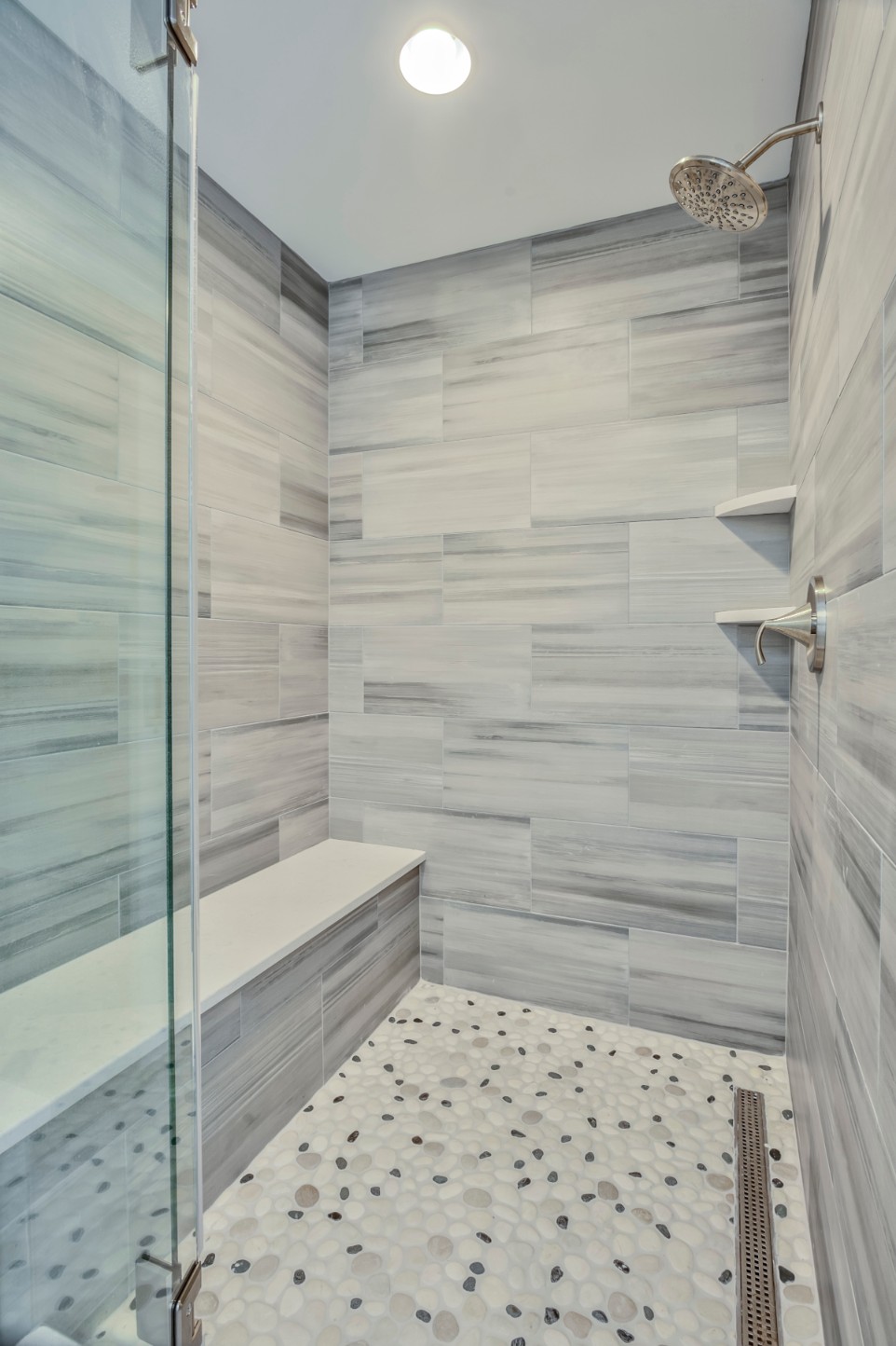 Canal Way Renovation in Bethany Beach DE - Bathroom - Shower with Stone Mosaic Floor and Grey Striped Wall Tiles
