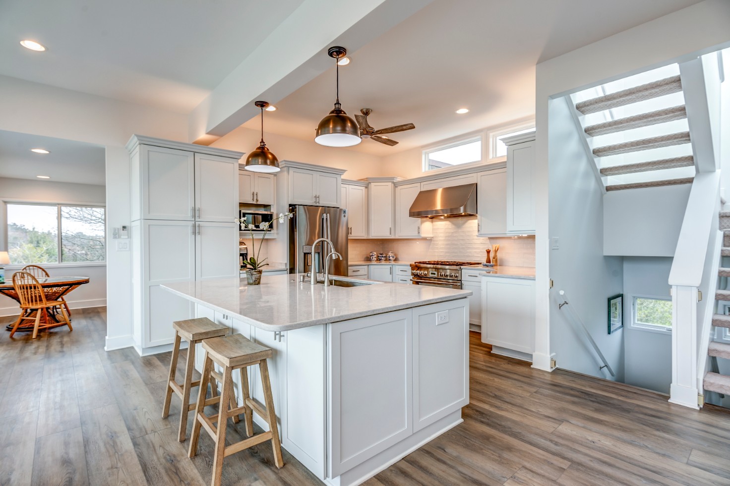 Cotton Patch Hills Renovation in Bethany Beach DE - Kitchen Island with Two Wooden Stools and Undermount Sink