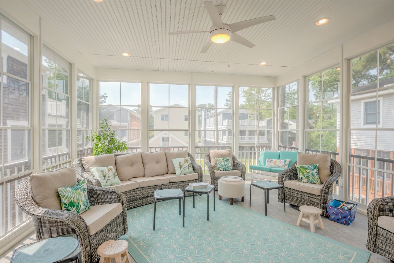 Sunroom with Rattan Furniture and Teal Accents