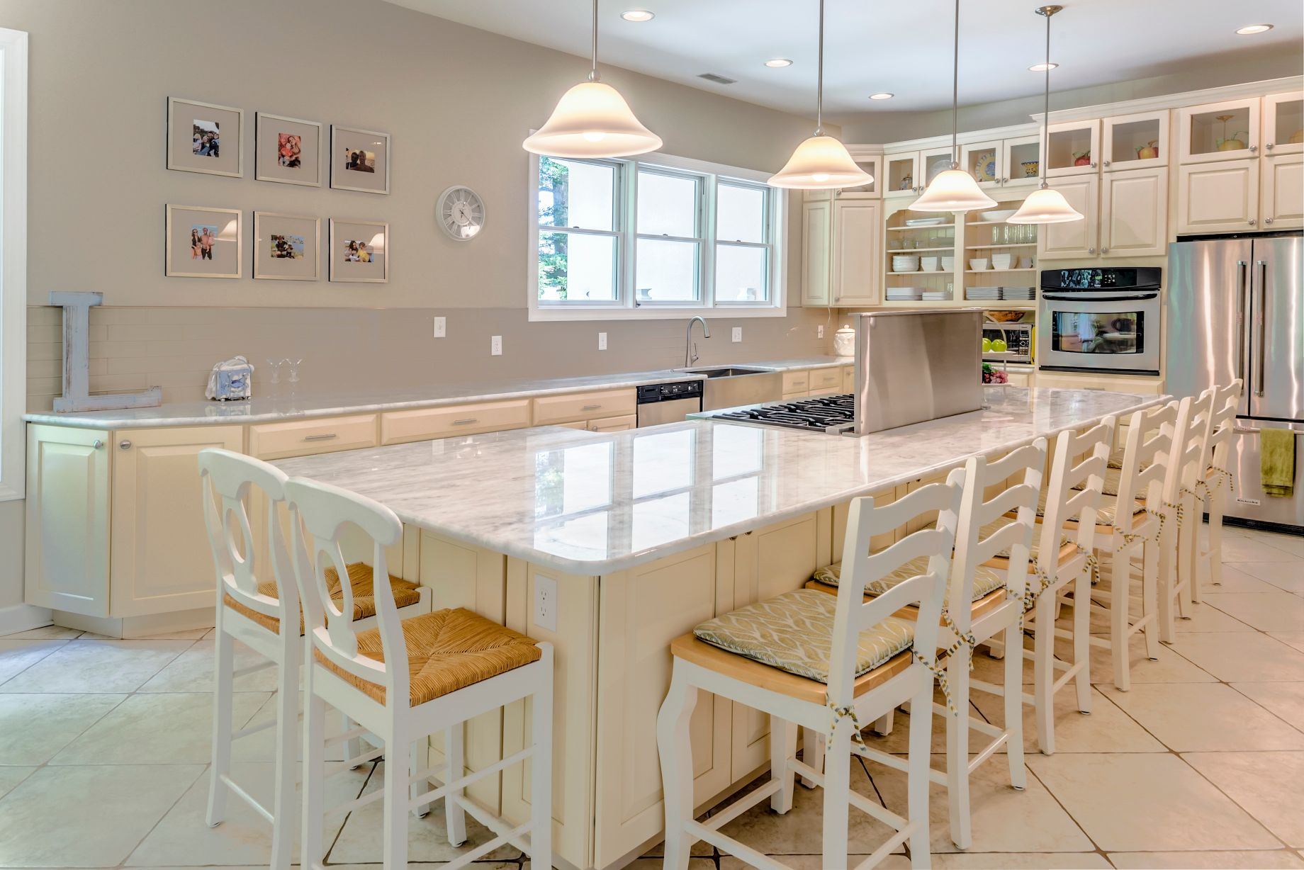 Kitchen in Juniper Court, Ocean Pines MD with Four Pendant Lights and White Chairs