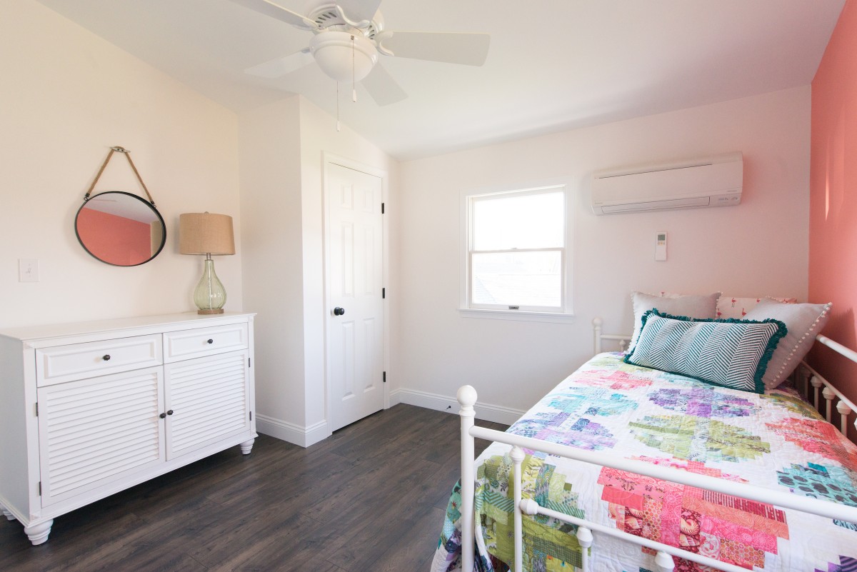 Kent Renovation Bethany Beach, DE Guest Bedroom with White Closet, Hanging Mirror and Dark Wood Flooring