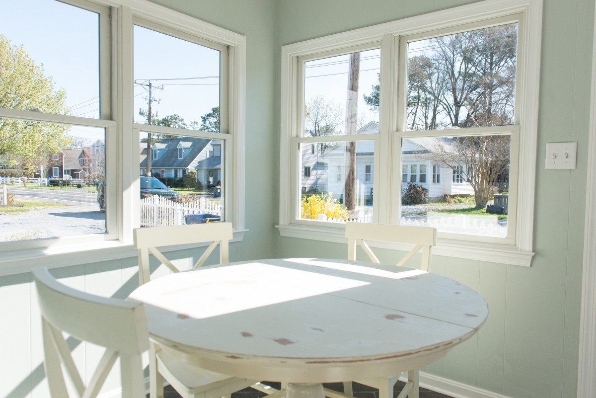 Kent Sunroom Renovation in Bethany Beach DE with White Vintage Distressed Round Table and White Windows Trim