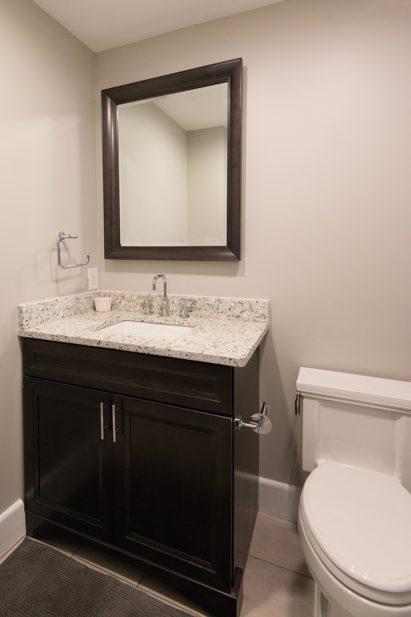 Bathroom Remodel in Kings Grant, Fenwick Island DE with Dark Wood Vanity, Mirror, Vetrazzo Blue Countertop and Tile Floor
