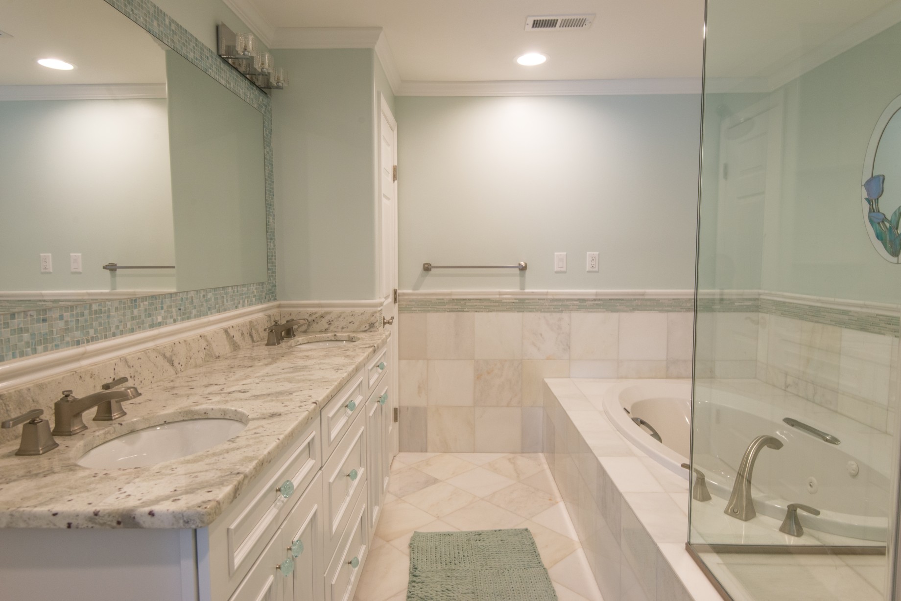 Kings Grant Renovation Vol.1 Bathroom with River Valley White Granite Top, White Vanity, Tub and Marble Tiles Floor