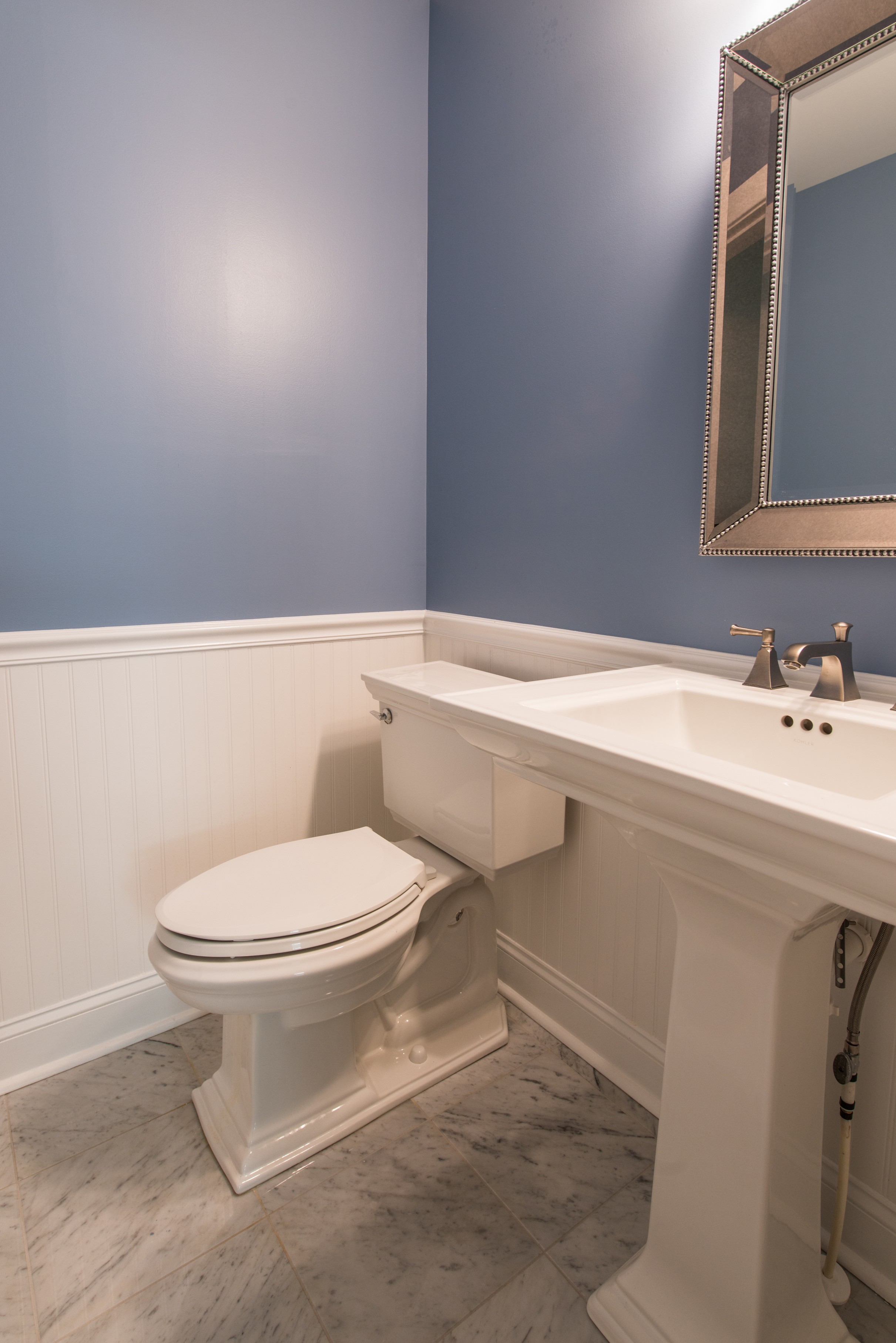 Bathroom Remodel in Ocean Ridge, Bethany Beach DE with Memoirs Pedestal Sink, Elongated Toilet and Framed Mirror