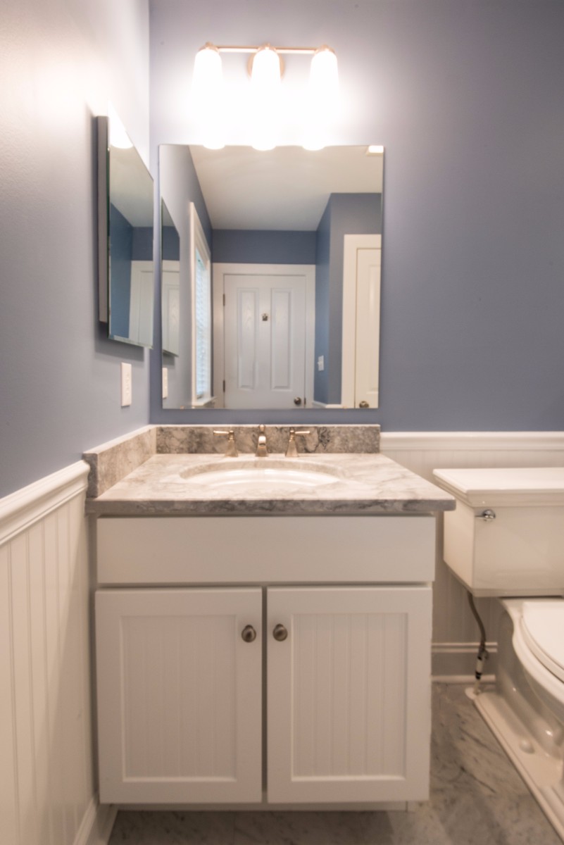 Bathroom Remodel in Ocean Ridge, Bethany Beach DE with White Wood Vanity, Light Grey Marble Top and Two Mirrors