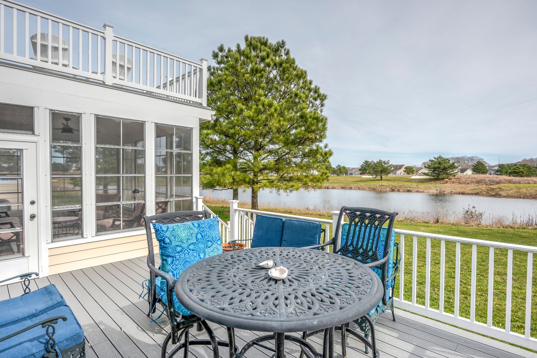 October Glory Exterior in Ocean View DE - Lower Deck with Vintage Metal Round Table