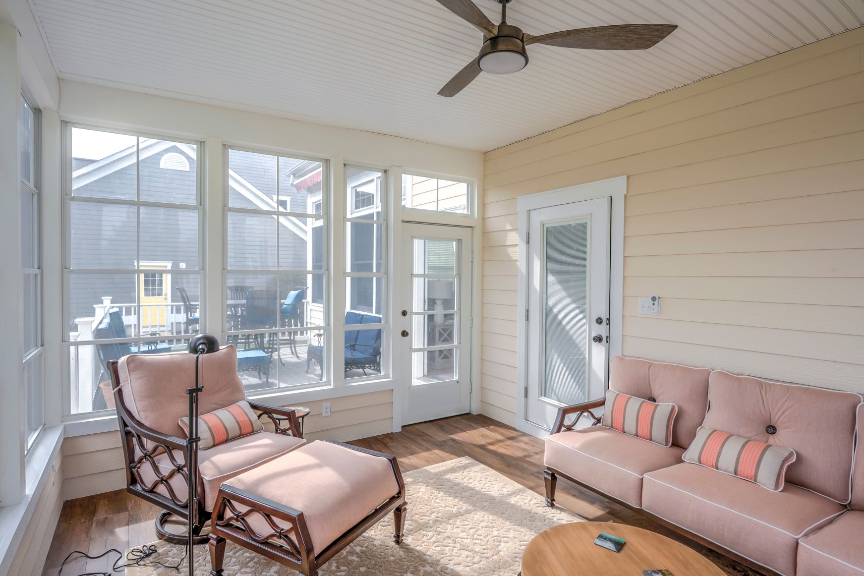 October Glory Exterior in Ocean View DE - Sunroom with Cozy Vintage Soft Furniture