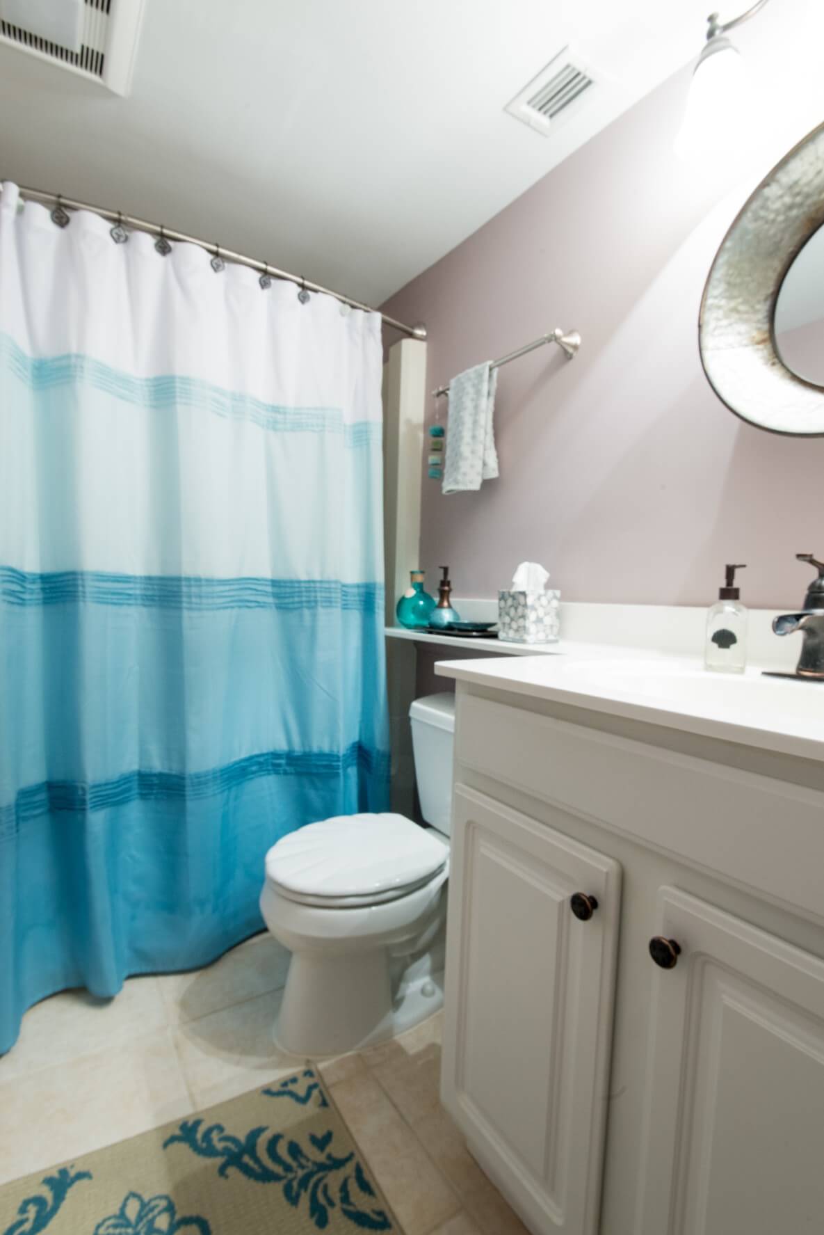 Sea Colony Condo Renovation Bethany Beach, DE Bathroom with Light Tile Floor, White Vanity Cabinet and Shower Curtain