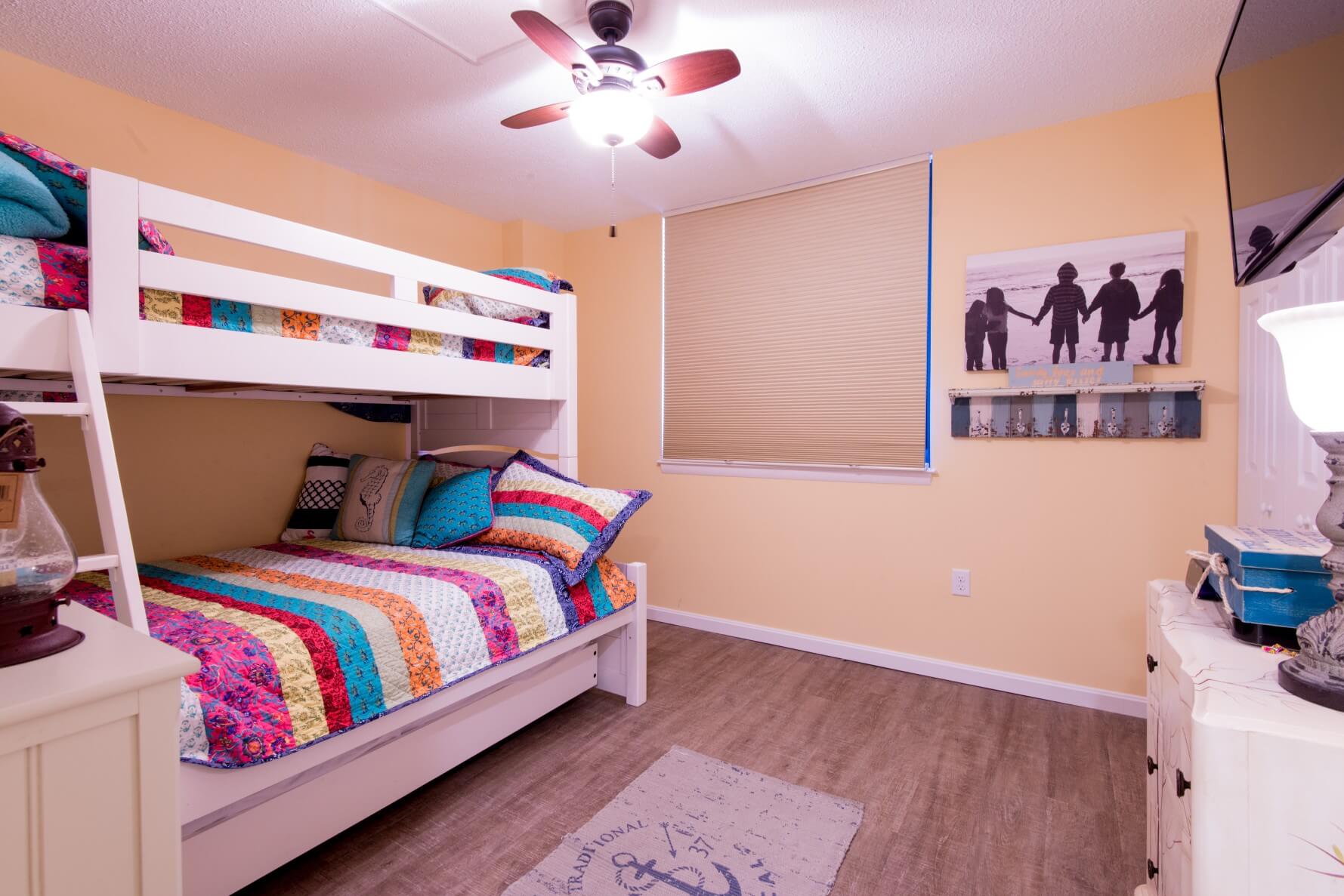 Sea Colony Condo Renovation Bethany Beach, DE Bunk Room with White Bunk Bed, Yellow Color Walls and Dark Wood Floor