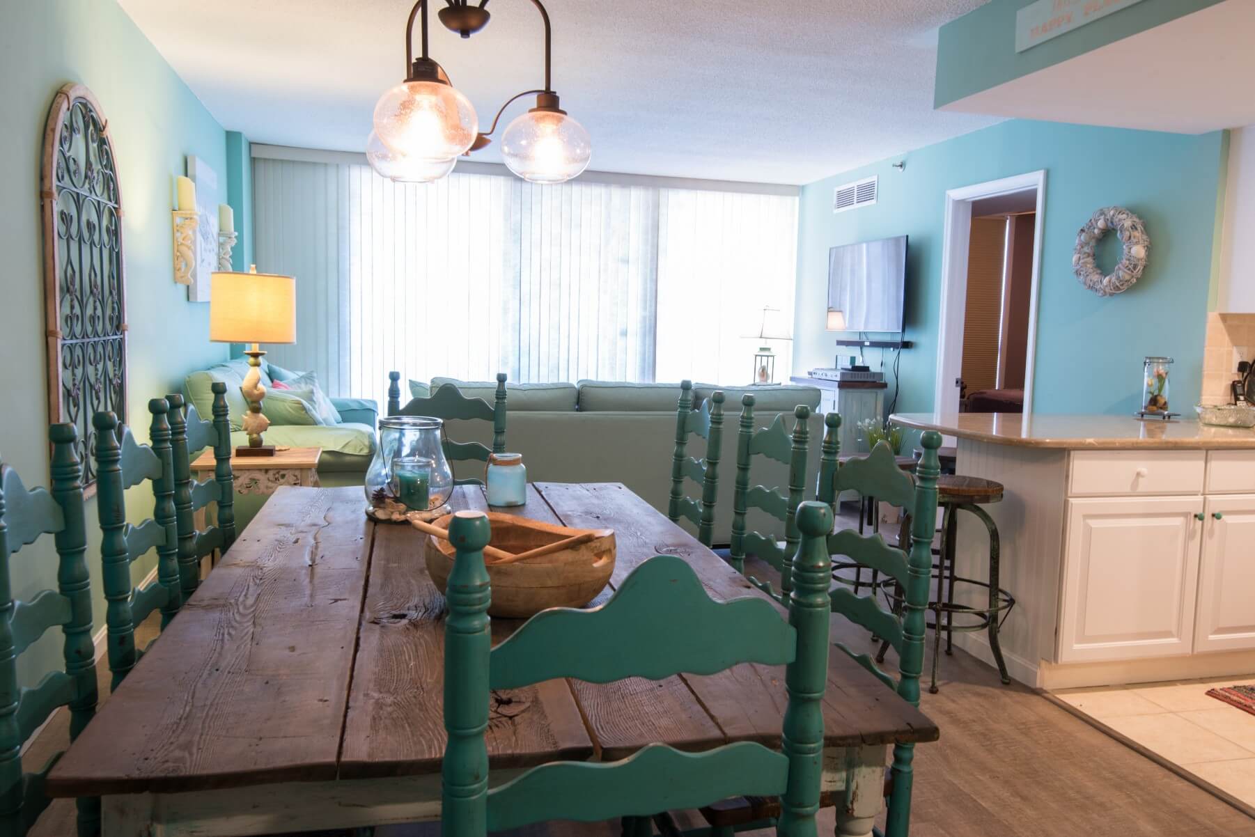 Sea Colony Condo Renovation Bethany Beach, DE with Turquoise Wall Paint, Vintage Wooden Dining Table and Vintage Chandelier