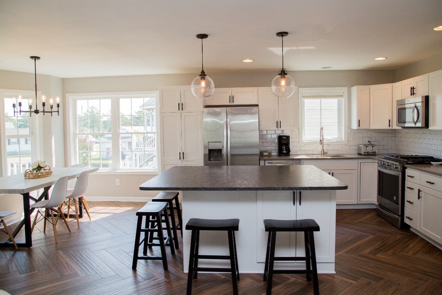 Kitchen Remodel with Dark Granite Countertop, Pendant Lighting and Recessed Lights