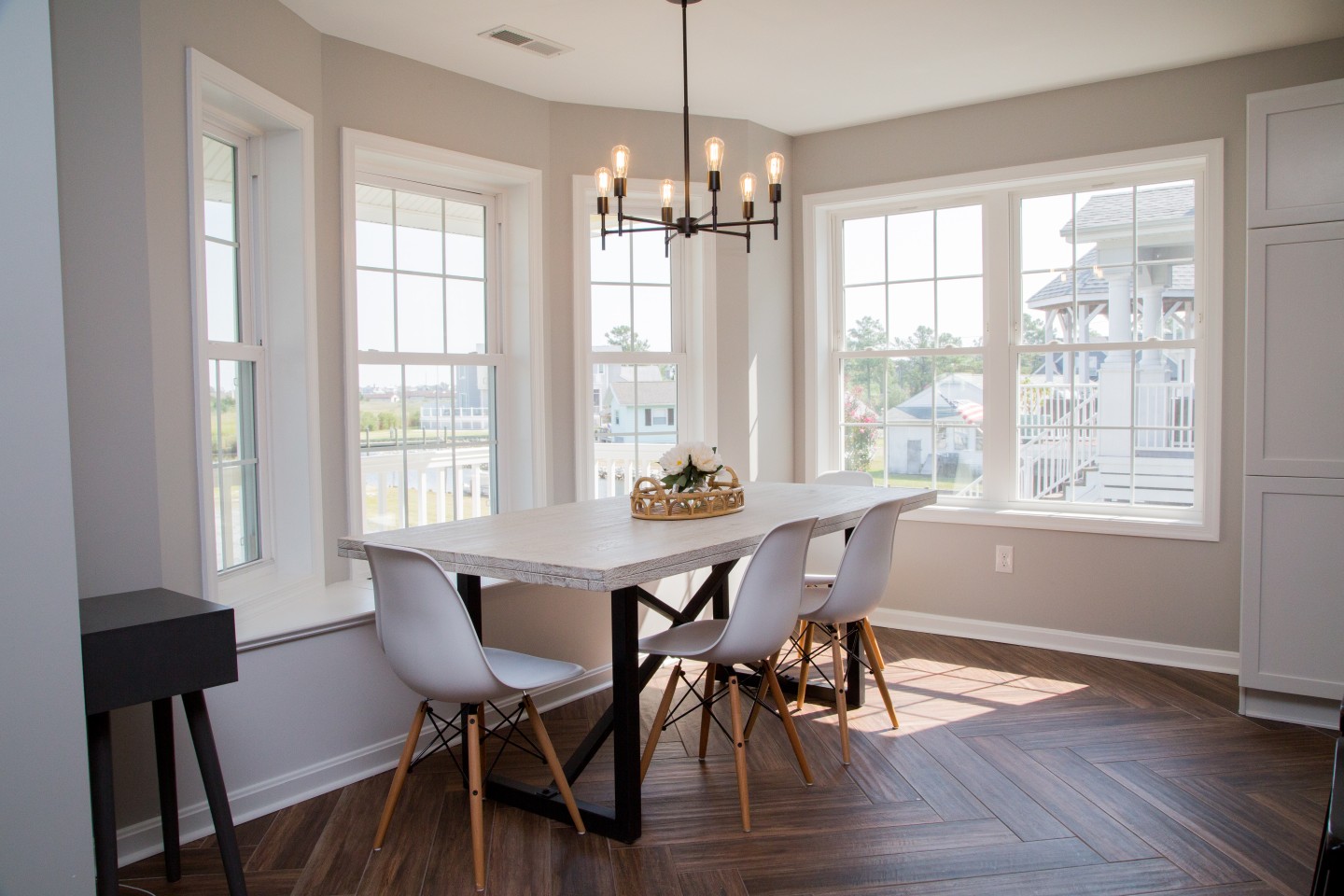 Kitchen Remodel with Window-Side Wooden Dining Table and White Chairs