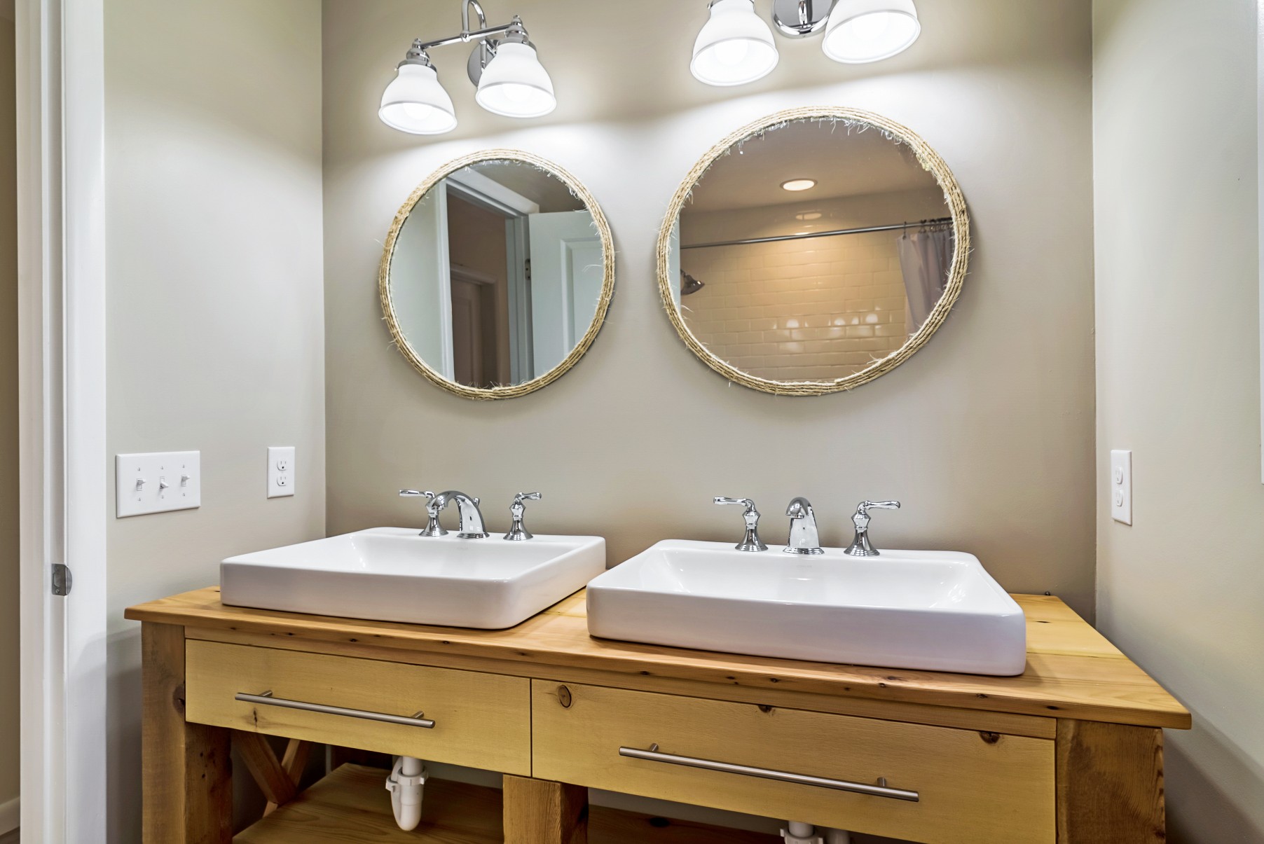 Bathroom Renovation in Wellington Parkway, Bethany Beach DE with Two Round Mirrors with Rope Outlining