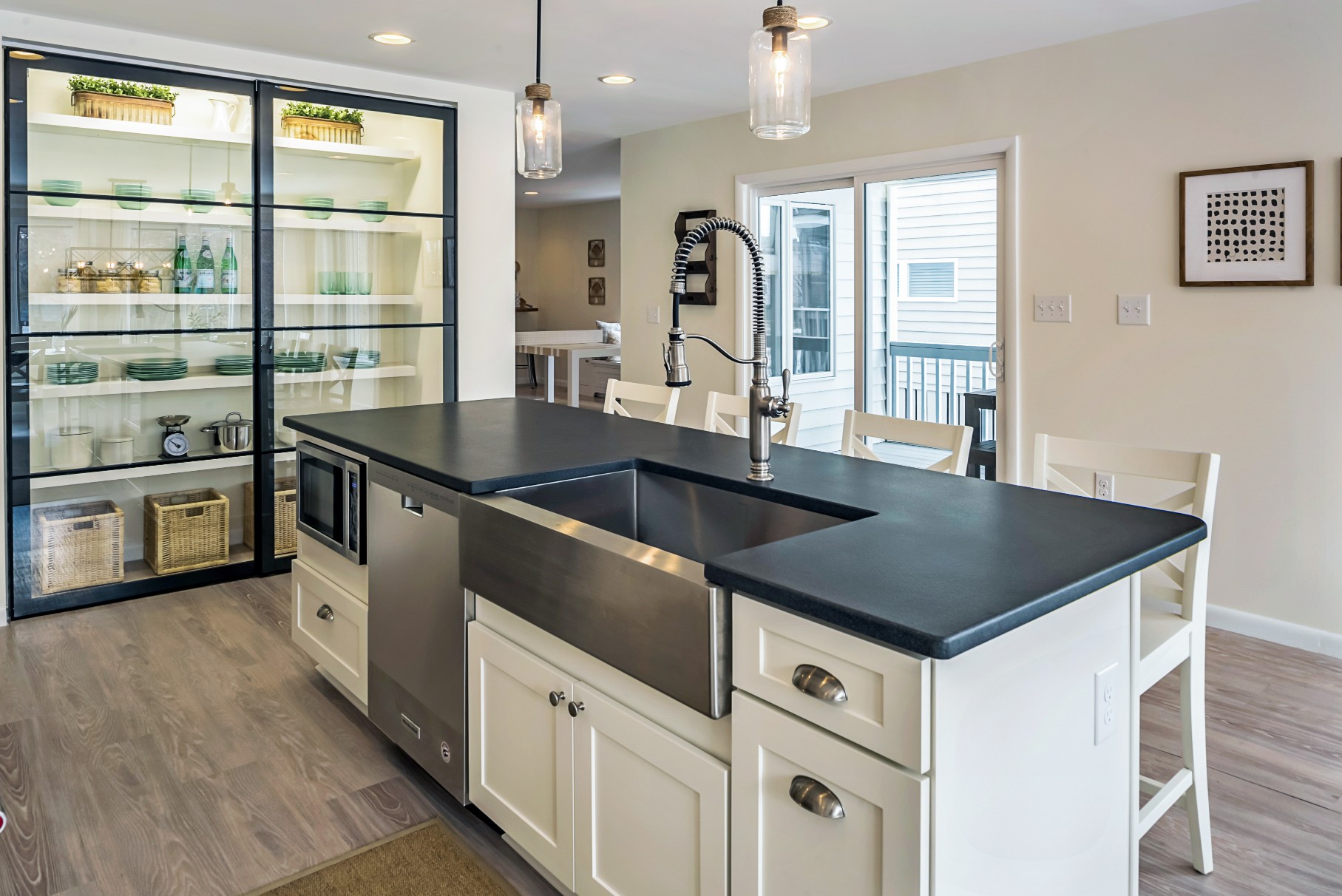 Kitchen Remodel in Wellington Parkway, Bethany Beach DE with Center Island with Black Countertop and Stainless Steel Sink