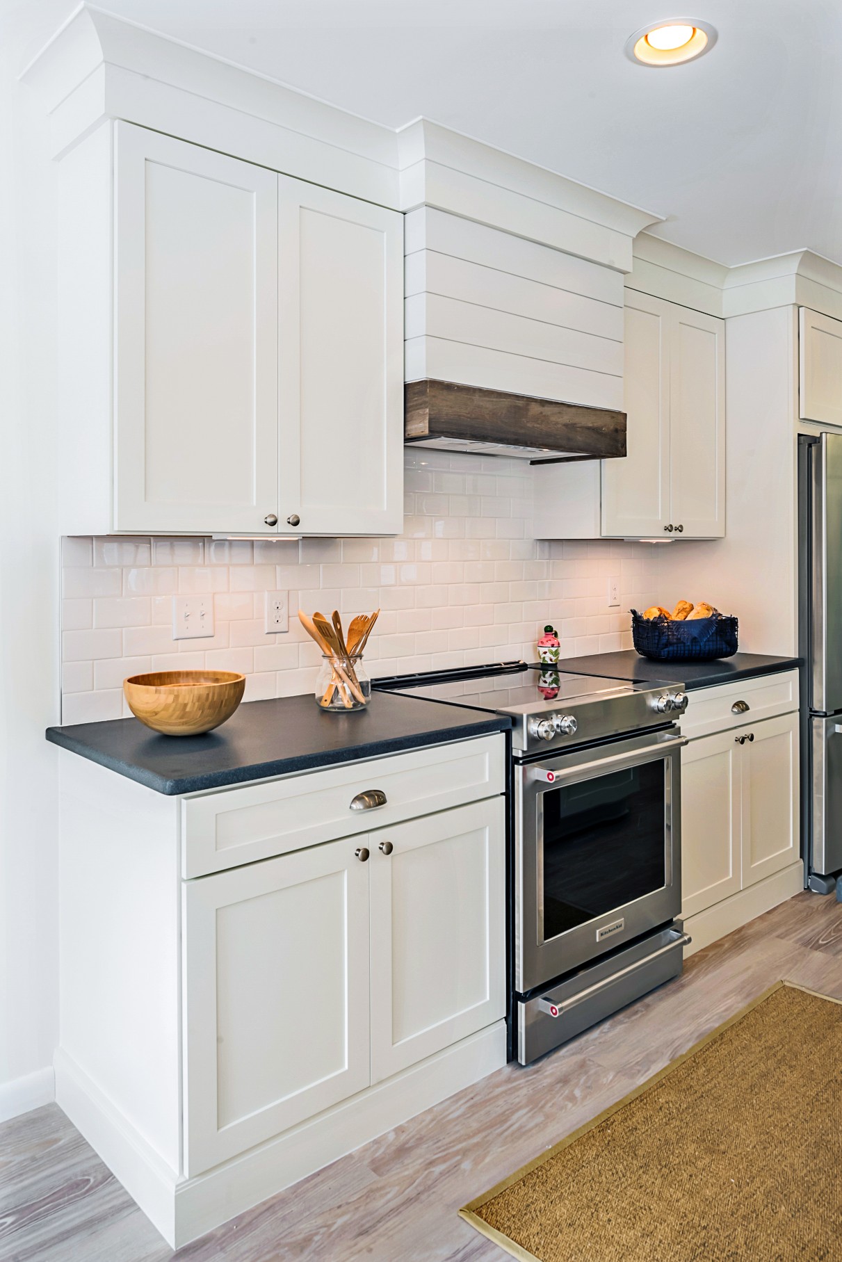 Kitchen in Wellington Parkway, Bethany Beach DE with White Cabinets, Black Granite Countertop and White Tile Backsplash