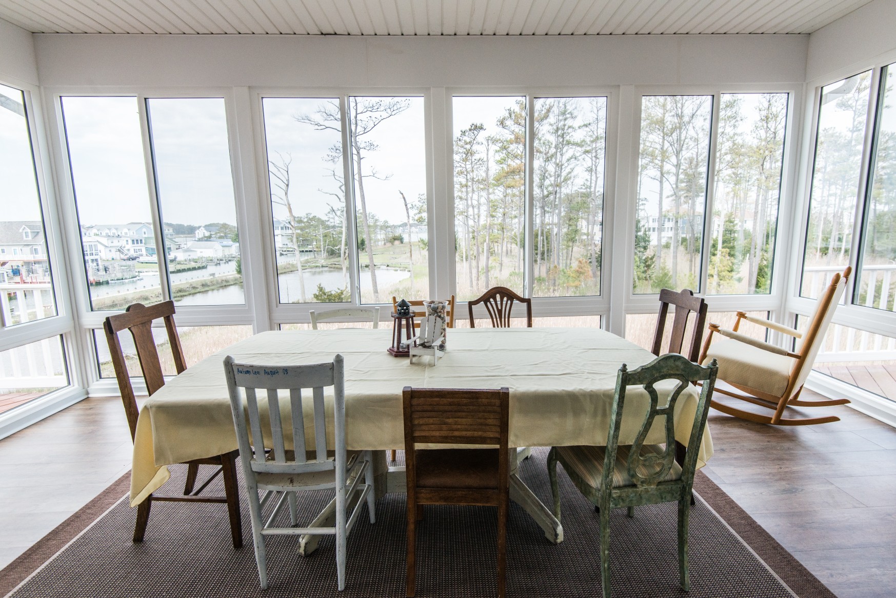 Whitesview Court House Lift New Addition in Ocean View DE Four Season Sunroom with Wood Flooring, Large Table and Rocking Chair